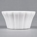 A CAC Bone White China Ramekin with wavy edges.