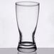 A close-up of a Libbey rim tempered pilsner glass with a clear white background.