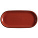 An Acopa Sedona Orange stoneware oval platter with black specks.