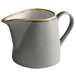 A white pitcher with a brown speckled rim.