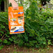 A person holding a bag of Terro Ant Killer Plus in an orange and white bag.