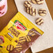 A package of Keebler Mini Fudge Stripes cookies with several round, striped cookies displayed on a napkin.