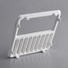 A white plastic rack with holes in it.