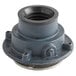 A Zurn cast iron floor drain with a round metal strainer with a black rim and a round hole.