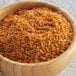 A bowl of McCormick Grill Mates Seafood Seasoning on a wood table.