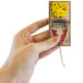 A hand holding a Victor Pest mousetrap box.