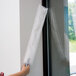 A person using an Unger ProFlat 75 duster to clean a room.