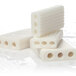 A group of white Soapbox soap bars with holes in the middle.