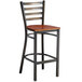 A Lancaster Table & Seating distressed copper finish metal bar stool with an antique walnut wood seat.