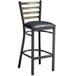 A Lancaster Table & Seating distressed copper metal bar stool with a black vinyl cushion.