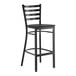 A black metal bar stool with a ladder back design and a black wood seat.