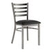 A Lancaster Table & Seating ladder back chair with a black vinyl seat.