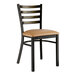 A Lancaster Table & Seating black metal ladder back chair with a light brown cushion.