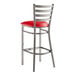 A Lancaster Table & Seating clear coat finish ladder back bar stool with a detached red vinyl padded seat.