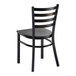 A black ladder back chair with a black wood seat and a distressed copper finish frame.