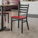 A Lancaster Table & Seating black and mahogany chair in a restaurant.