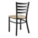 A Lancaster Table & Seating black finish wooden chair with a driftwood seat.