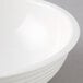 A close up of a white Cambro ribbed bowl.