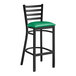 A Lancaster Table & Seating black ladder back bar stool with a green padded seat.