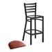 A Lancaster Table & Seating black ladder back bar stool with a burgundy vinyl padded seat.