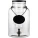A Tablecraft glass beverage dispenser with a black label.