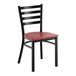 A black metal ladder back chair with a mahogany wood seat.