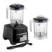 A commercial blender with a black base, touchpad controls, and two clear 48 oz. containers with lids.