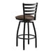 A Lancaster Table & Seating black ladder back swivel bar stool with dark brown vinyl padded seat.