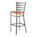 A Lancaster Table & Seating metal bar stool with a wooden seat.