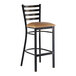 A metal bar stool with a distressed copper finish, ladder back design, and a light brown vinyl padded seat.