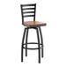 A black metal bar stool with a ladder back design and an antique walnut wood seat.