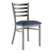 A Lancaster Table & Seating metal ladder back chair with a navy blue vinyl cushion.