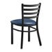 A black Lancaster Table & Seating metal chair with navy blue cushion.