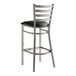 A Lancaster Table & Seating ladder back bar stool with a black vinyl padded seat.