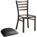 A black Lancaster Table & Seating ladder back chair with a black cushion on the seat.