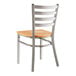 A Lancaster Table & Seating metal chair with a natural wood seat and ladder back.