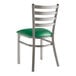 A Lancaster Table & Seating metal ladder back chair with a green vinyl padded seat.