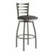 A Lancaster Table & Seating black vinyl padded swivel bar stool with a clear coat finish and silver accents.