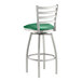 A green vinyl padded Lancaster Table & Seating swivel bar stool with metal legs.