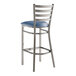 A metal bar stool with a ladder back design and a navy blue vinyl padded seat.