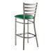 A Lancaster Table & Seating Ladder Back Bar Stool with a green vinyl seat.