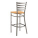 A Lancaster Table & Seating metal bar stool with natural wood seat.