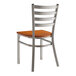 A Lancaster Table & Seating metal chair with a wood seat and back.
