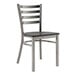A Lancaster Table & Seating metal chair with black wood seat and ladder back.