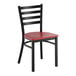 A black ladder back chair with a mahogany wood seat.