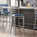 Lancaster Table & Seating ladder back bar stools with navy blue padded seats.