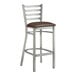 A Lancaster Table & Seating metal bar stool with a dark brown vinyl padded seat.