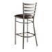 A Lancaster Table & Seating metal ladder back bar stool with a dark brown vinyl padded seat.