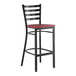 A black metal ladder back bar stool with a mahogany wood seat.