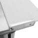 A close up of a white table top with a metal strip.